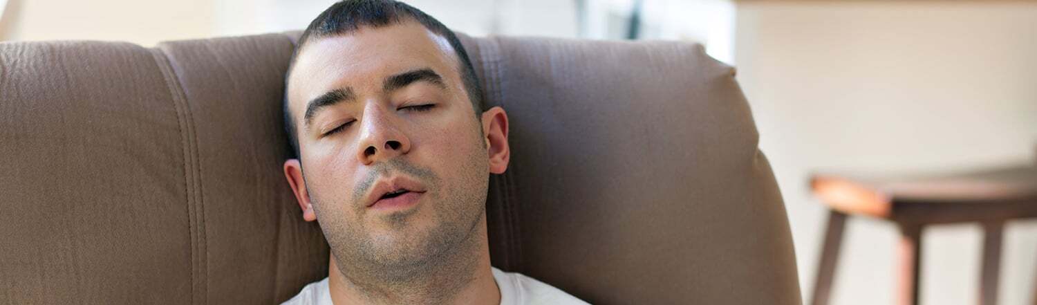 Man resting on a sofa